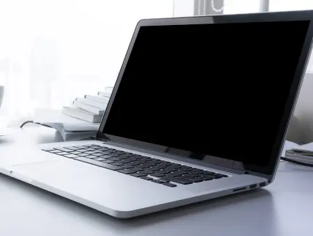 A laptop containing an SSD sitting on a desk in an office.